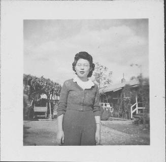 [Woman with eyeglasses and ruffled collar standing outdoors, half-portrait, Rohwer, Arkansas, November 10, 1944]