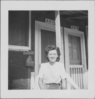 [Young woman wearing eyeglasses in front of barracks porch, 2-7-C, Rohwer, Arkansas, September 23, 1944]