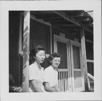 [Two young women sitting on barracks porch, 2-7-C, Rohwer, Arkansas, September 23, 1944]