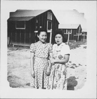[Two women linking arms, three-quarter portrait, Rohwer, Arkansas]