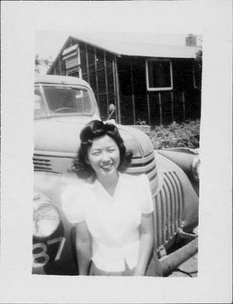 [Young woman standing in front of truck, Rohwer, Arkansas]
