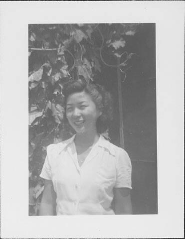 [Woman in white blouse and vines, half-portrait, Rohwer, Arkansas]