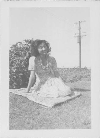 [Young woman sitting on quilt on grass, Rohwer, Arkansas, September 3, 1944]