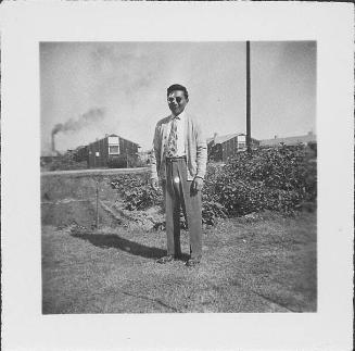 [Man with bandaged eye and sunglasses standing outside, Rohwer, Arkansas, November 2, 1944]