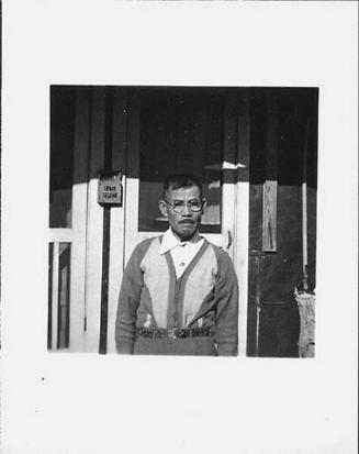 [Mustached older man in eyeglasses in front of mailbox and door, Rohwer, Arkansas, 1942-1945]