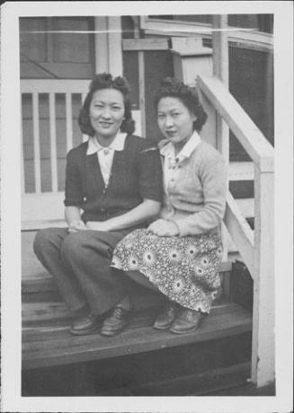 [Two young women sitting on barracks porch steps, Rohwer, Arkansas, JAN 11