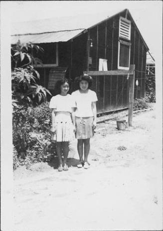 [Two girls standing in front of barracks, Rohwer, Arkansas, July 23, 1945]