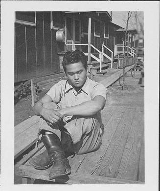 [Young man sitting on deck, Rohwer, Arkansas, February 18, 1945]