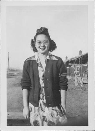 [Sakaye Nakatsuru in floral print dress, sweater and eyeglasses, three-quarter portrait, Rohwer, Arkansas, January 29, 1945]