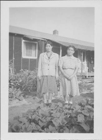 [Two older women standing on path between gardens, Rohwer, Arkansas, October 1944]