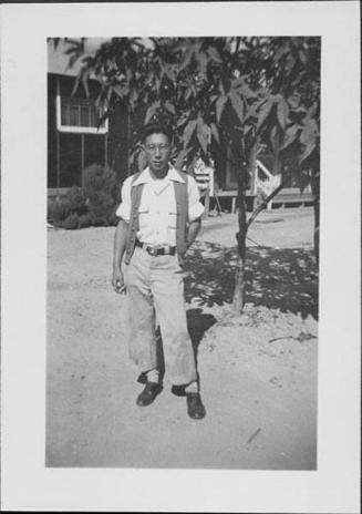 [Young man in vest stands in front of tree, Rohwer, Arkansas, October 10, 1944]
