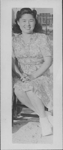 [Young woman sitting with hands folded, portrait, Rohwer, Arkansas]