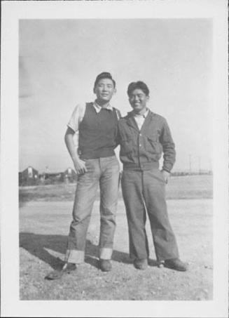 [Two young men standing in open area, Rohwer, Arkansas, 1942-1945]