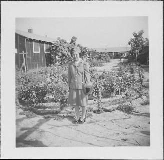 [Woman in United States Cadet Nurse Corps uniform standing in garden, full-length portrait, Rohwer, Arkansas, September 23, 1944]