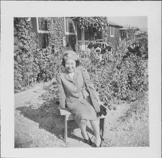 [Woman in United States Cadet Nurse Corps uniform sitting in garden, seated portrait, Rohwer, Arkansas, September 23, 1944]