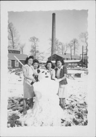 [Four women and snowman, Rohwer, Arkansas]