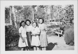[Four young women standing on wooded path, Rohwer, Arkansas, October 28, 1944]