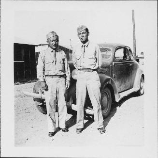 [Two men in United States Army uniform standing in front of automobile, Rohwer, Arkansas, August 20, 1944]