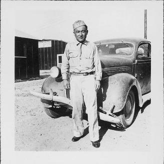 [Man in United States Army uniform standing in front of automobile, Rohwer, Arkansas, August 20, 1944]