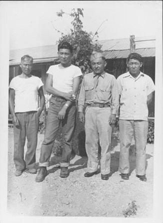 [United States Army soldier and three men in front of barracks, Rohwer, Arkansas, August 20, 1944]