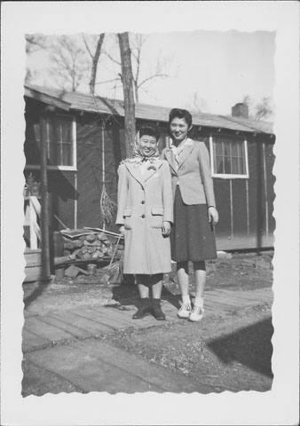 [Two women standing on wooden footpath, full-length portrait, Rohwer, Arkansas]