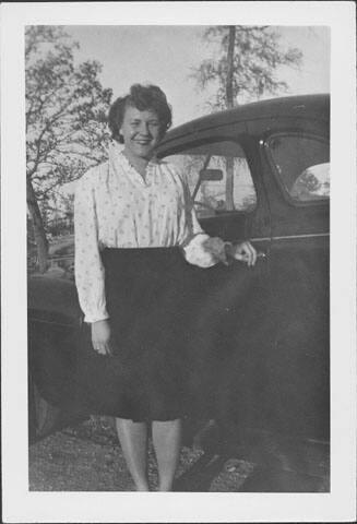 [Caucasian woman standing next to automobile, Rohwer, Arkansas, November 1944]