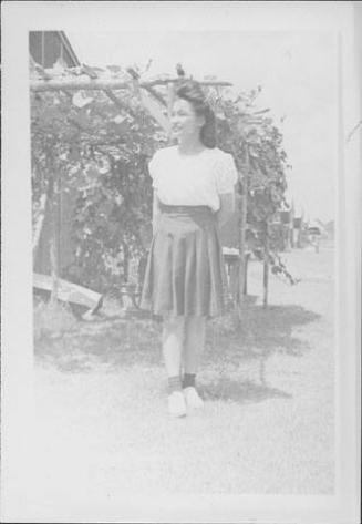 [Young woman standing in front of arbor, full-length portrait, Rohwer, Arkansas]