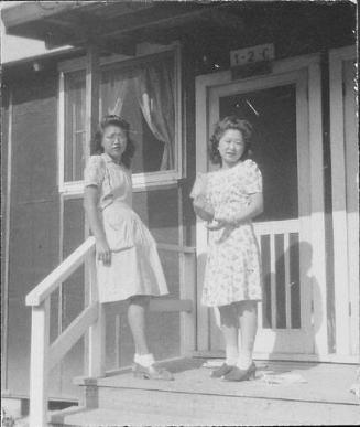 [Two young women standing on barracks porch, 1-2-C, Rohwer, Arkansas, June 5, 1945]