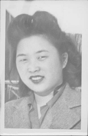 [Young woman in polka dot blouse and herrringbone jacket, head and shoulder portrait, Rohwer, Arkansas]