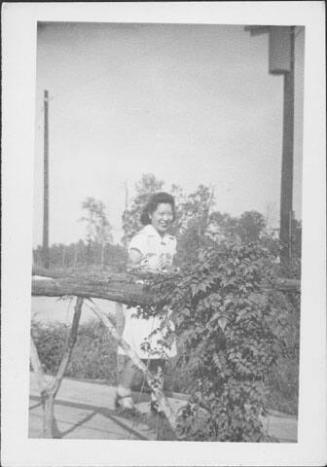 [Woman in candy-striper uniform on footbridge, Rohwer, Arkansas, October 5, 1944]
