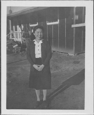 [Woman standing in front of barracks, full-length portrait, Rohwer, Arkansas]