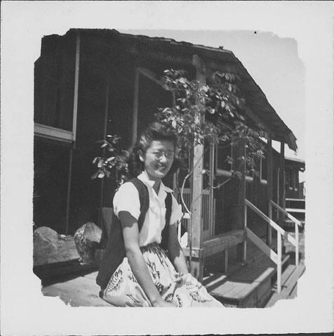 [Woman with eyeglasses sitting in front of barracks, Rohwer, Arkansas]