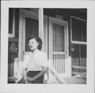 [Woman with eyeglasses leaning against railing of 2-7-C, half-portrait, Rohwer, Arkansas, September 23, 1944]