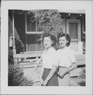 [Two women wearing eyeglasses in front of barracks porch with vine, Rohwer, Arkansas, September 23, 1944]