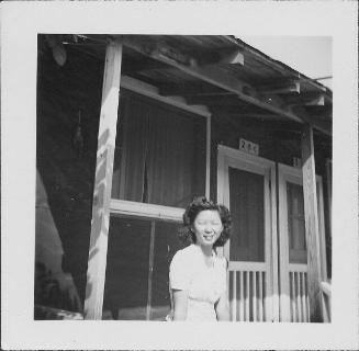 [Woman in front of barracks porch, 2-7-C, Rohwer, Arkansas, September 23, 1944]