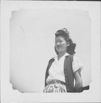 [Woman in eyeglasses, vest, and leaf-print skirt, half-portrait, Rohwer, Arkansas]