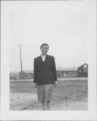 [Woman in dark jacket and plaid skirt, three-quarter portrait, Rohwer, Arkansas]