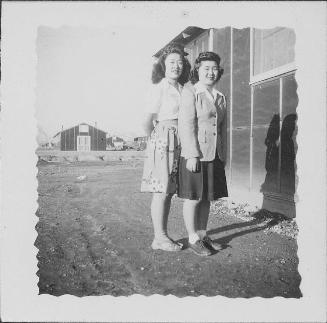 [Two women standing together next to barracks, Rohwer, Arkansas, April 1944]