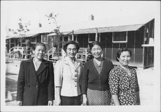 [Four women standing in front of barracks, half-portrait, Rohwer, Arkansas]
