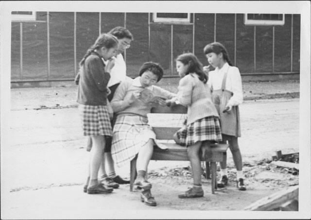 [Five girls reading book on bench, Rohwer, Arkansas, February 4, 1945]