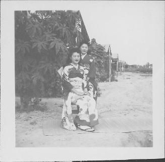 [Two young women in kimono outside on a goza mat, Rohwer, Arkansas]