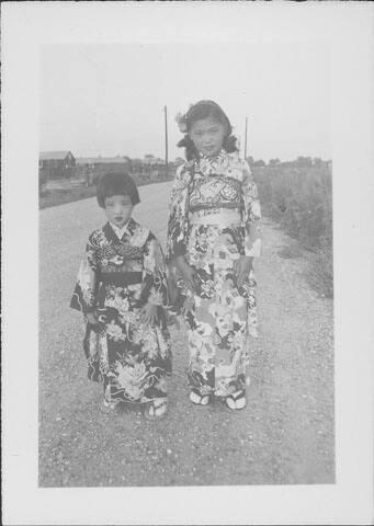 [Two girls in kimonos standing on road, Rohwer, Arkansas, August 14, 1944]