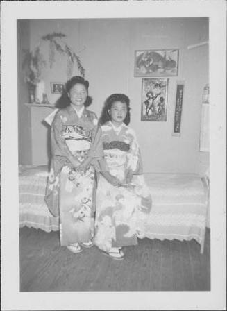 [Two young women in kimono in a bedroom, Rohwer, Arkansas]