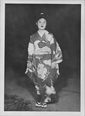 [Kimiko Yamasaki in kimono standing in darkness, full length portrait, Rohwer, Arkansas]