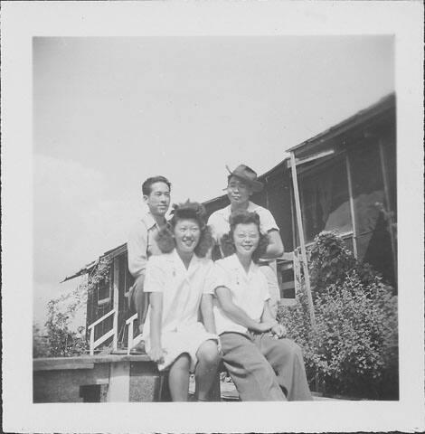 [Two women and two men in front of barracks, Rohwer, Arkansas]