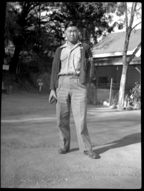 Blurry image of man standing in dirt driveway