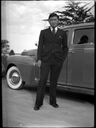 Man in a suit in front of car