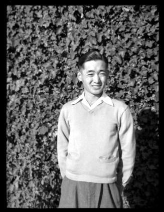 Frank Miwa in front of ivy-covered wall