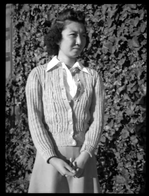 Mae Miwa in front of ivy-covered wall