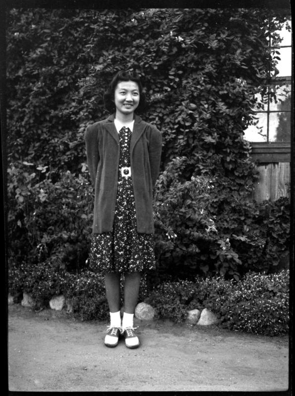 Mae Miwa in front of ivy-covered wall